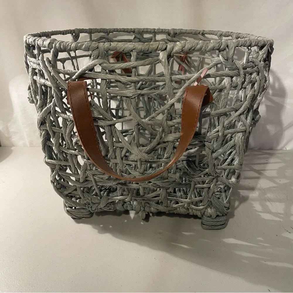 Woven gray Basket with brown Leather Handles width 14” deep 11” 4 metal feet